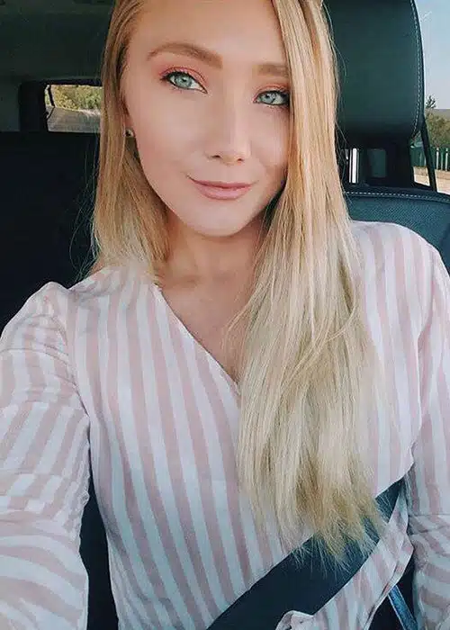 Sexy blonde shows off her green eyes to you.